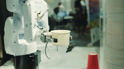Robot with artificial intelligence making coffee on coffee machine. Close up shot