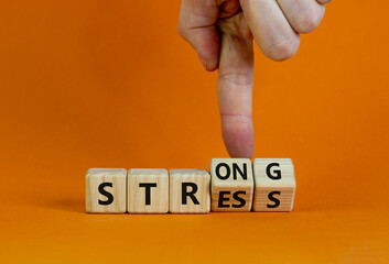 Strong stress symbol. Businessman turns wooden cubes with words 'strong stress'. Beautiful orange background, copy space. Business and strong stress concept.