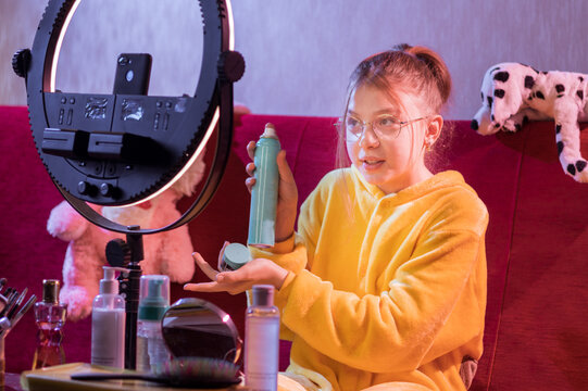 The girl advertises cosmetics. The girl shows cosmetics to the camera. Smile at the camera.