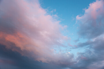 closeup to evening sunset background with pink clouds and blue sky