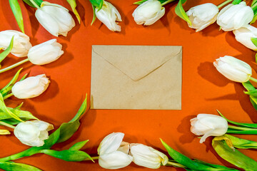 A bouquet of beautiful tulips and an envelope with congratulations