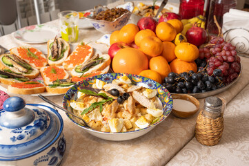 Salad and sandwiches served on table at russian new year eve