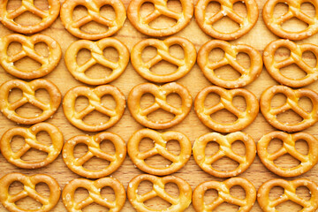 abstract background baked pretzels on wooden surface