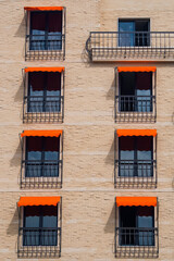 Classic Rectangular Window With Wrought Iron In European Style With Orange Awnings