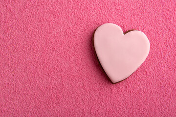 Fototapeta premium Cookies in shape of hearts with sugar icing on pink background. Space for text