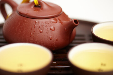Chinese yixing teapot and teacups on the wooden board