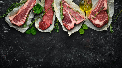 Meat. Set of raw steaks - t-bone, tomahawk, striploin, tenderloin, new york steak. Flat lay top...