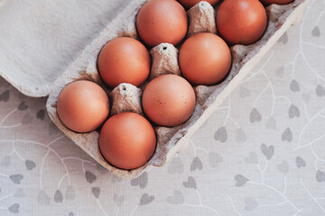 Raw brown eggs in egg box. Top view, copy space