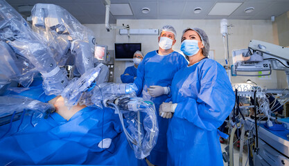 Doctors look at screens with working operation process. Medics check the workflow of surgery...