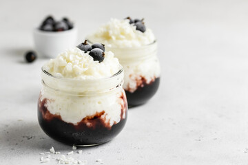 Coconut milk vegan dessert  rice pudding in glass jars. Space for text.