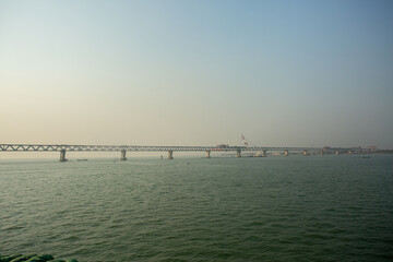 Fototapeta na wymiar The PADMA Multipurpose Bridge is under constraining working progress can be seen on the river Padma.