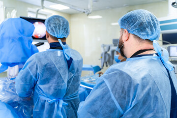 Qualified and competent medics provide operation in modern up-to-date operation room. Closeup.