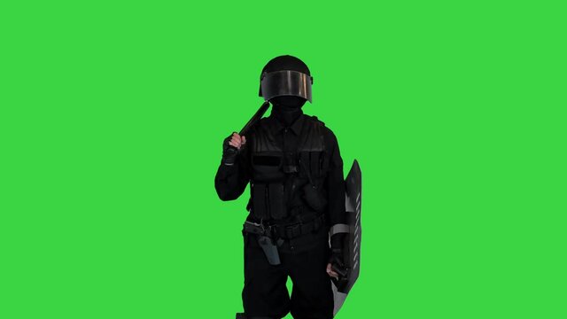 Riot policeman standing and doing nothing waiting on a Green Screen, Chroma Key.
