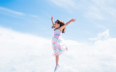 Obraz na płótnie Canvas Forward to success. fashion and beauty. jumping and fly. smiling child with cheerful look. childhood happiness. pretty teenage girl in dress outdoor. kid summer fashion. cheerful and carefree