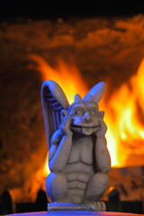 Closeup of gargoyle with fire in background
