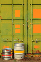 Colorful beer barrels next to metal container 