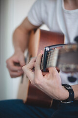 Acoustic guitar guitarist playing. Musical instrument with performer hands. joy of good music. Chord practice during quarantine. Learning a new skill