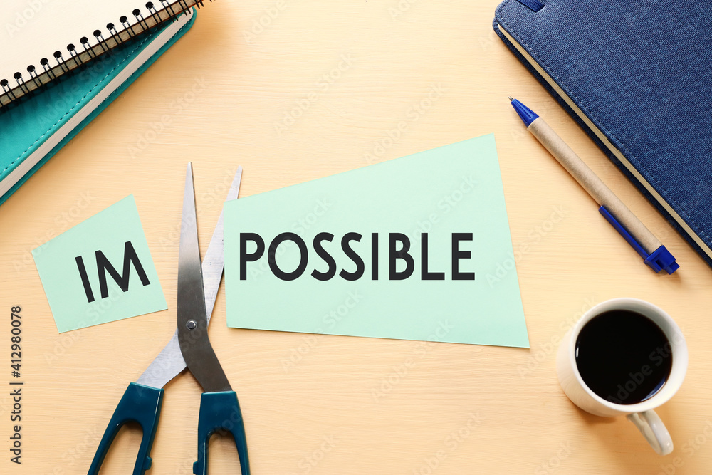 Poster card with the text impossible, cutting the word im so it written possible. success and challenge con