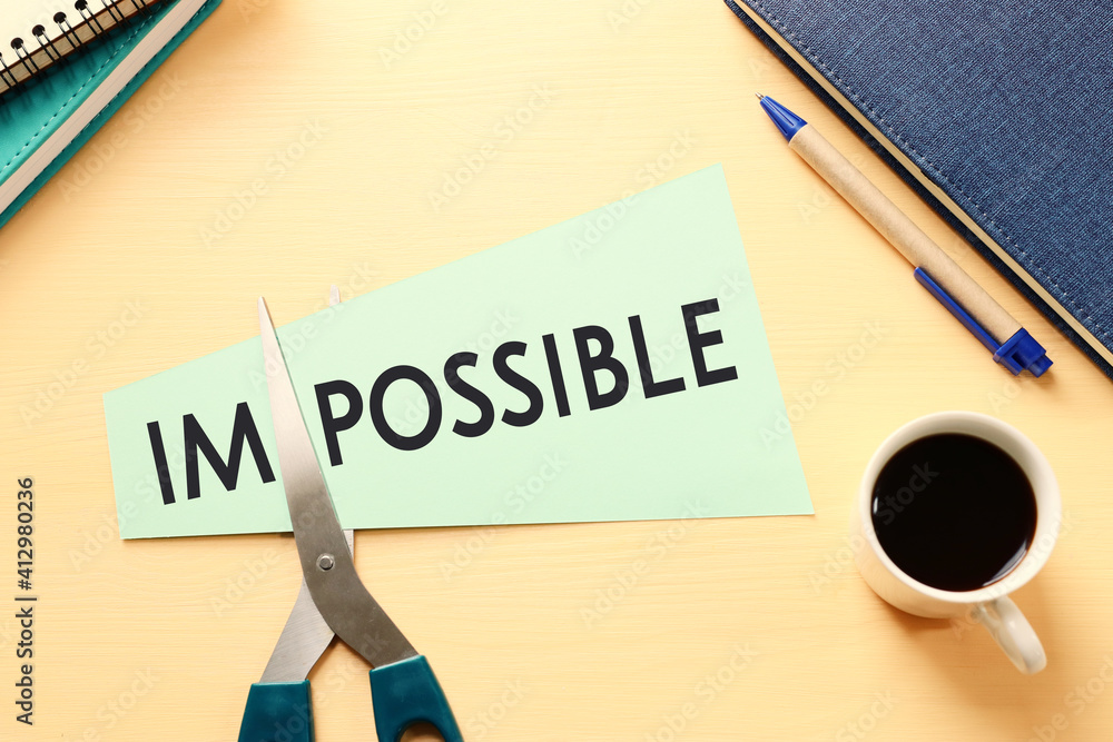 Poster card with the text impossible, cutting the word im so it written possible. success and challenge con