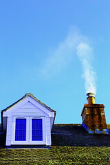 Smoke from the chimney against blue sky