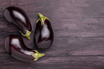 eggplants on a dark wooden background
