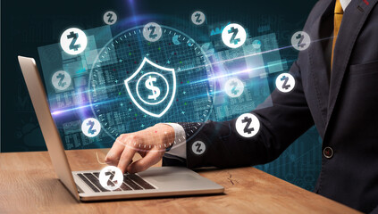 business hand working in stock market with dollar shield icons coming out from laptop screen