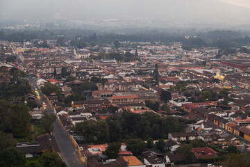 Fototapeta premium Aerial view of Antigua Guatemala colonial city at sunset on a cold day - small magical town