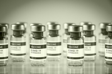 Covid-19 vaccine bottles on a black and white background