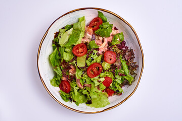 salad with tomatoes, lettuce leaves. on a white background