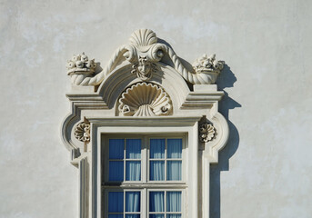 Detail of a stone window with sculptures baroque, on the facade of the Royal Palace of Venaria