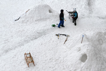 Kinder spielen im Winter bauen Iglus