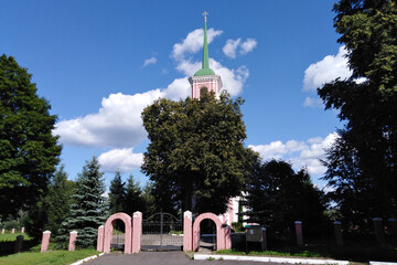 The spire of the Orthodox church and the tree growing in front of it.