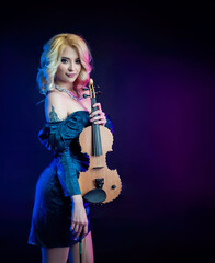 Fototapeta na wymiar portrait of a blonde woman playing a violin in neon light