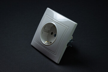 White socket on a black background. Flush-mounted white socket.