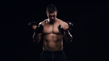 Fit and sporty bodybuilder over black background. Sportsman in studio. Sport and fitness concepts.