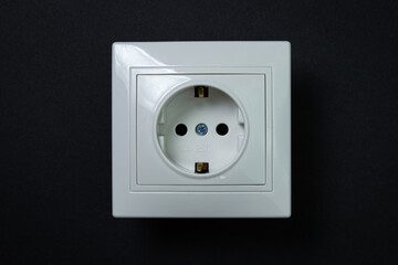 White socket on a black background. Flush-mounted white socket.