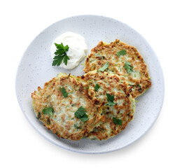 Delicious zucchini fritters with sour cream and parsley isolated on white, top view