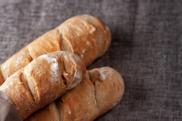 French baguettes on a table covered with cloth. Selective focus.