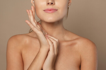 Close frame of neck and arms of a young woman. Skin care concept, skin hydration