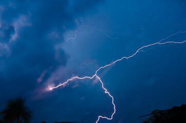 Storm, beautiful rays cutting through the skies and brightening the night.