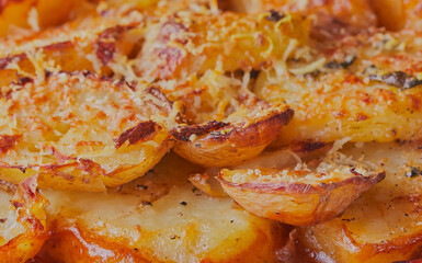 Baked sliced potatoes with melting cheese.