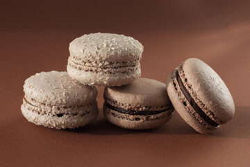 Chocolate chip cookies close-up, on a brown background. Macarons. Traditional French sweets. Horizontal photo.