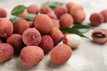 Fresh ripe lychee fruits on light grey table
