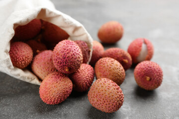Fresh ripe lychee fruits on grey table
