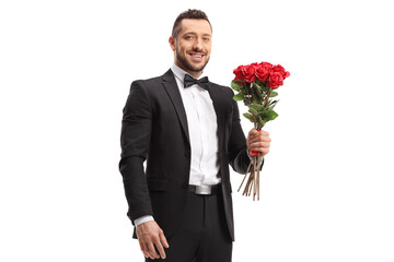 Handsome man in a suit holding a bunch of red roses