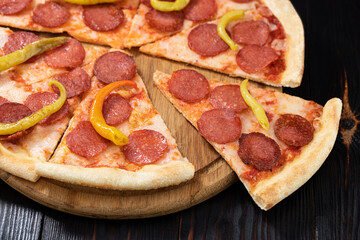 Tasty pepperoni pizza on wood background . Top view of hot pepperoni pizza. With cop