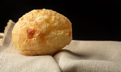 Cheese bread from Brazil, Arrangement with cheese bread on fabric with black background, selective focus.