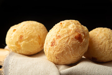 Cheese bread from Brazil, Arrangement with cheese bread on fabric with black background, selective focus.