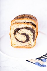 Poppy seed roll on a white background