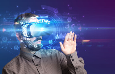 Businessman looking through Virtual Reality glasses with TESTING inscription, innovative technology concept